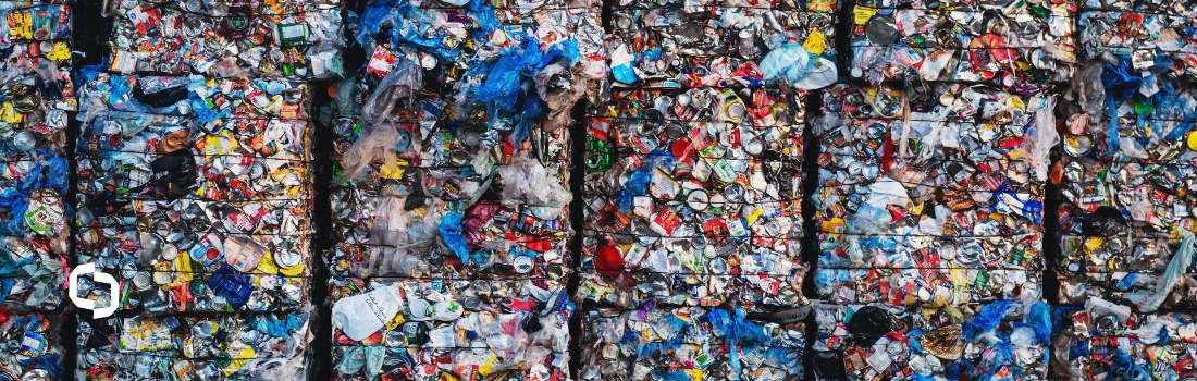 Stacks of compressed plastic waste and other recyclables, highlighting the growing plastic waste problem and the need for effective recycling solutions.