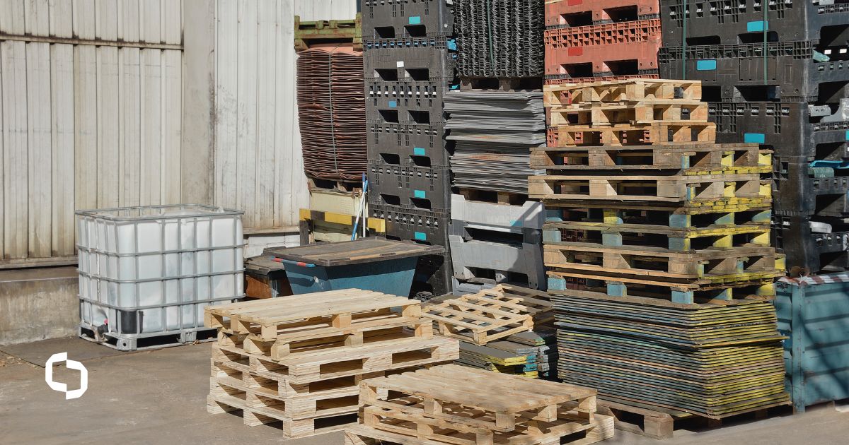 Huge piles of different types of pallets at a warehouse.