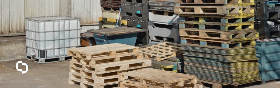 Huge piles of different types of pallets at a warehouse.