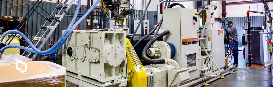 Industrial setup featuring a compounding machine and pelletizing machine in a manufacturing facility, used for blending and forming plastic materials into uniform pellets.