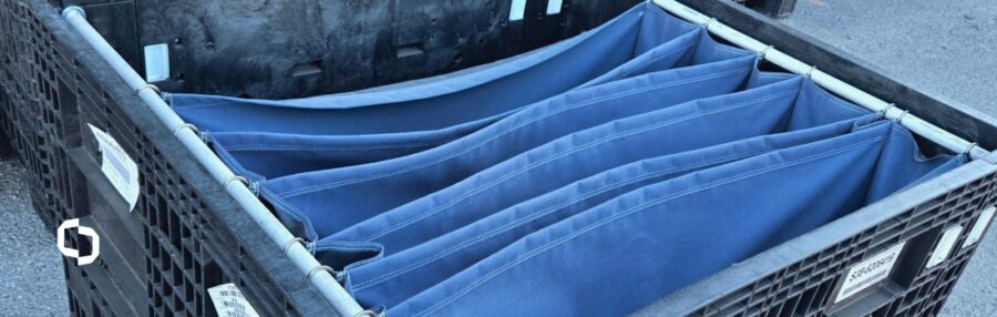 A dunnage rack with multiple blue fabric compartments designed for securely organizing and transporting parts; a visual example for explaining what dunnage is and how custom dunnage solutions optimize protection and space in logistics.