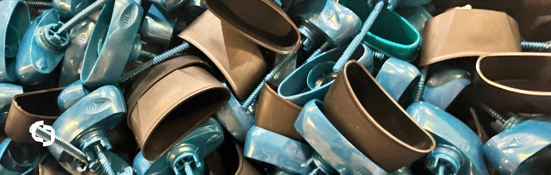 Close-up of molded blue and black plastic hardware parts produced by Extera, reflecting current plastic trends and innovation in reducing plastic pollution through advanced manufacturing.