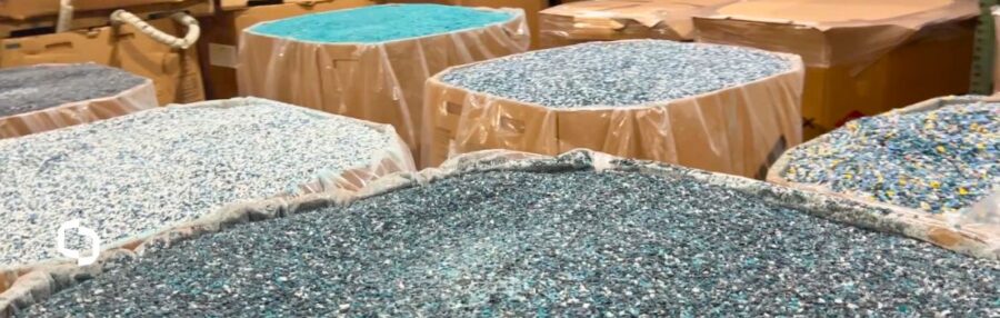 Various types of recycled plastic materials sorted in bulk containers at Extera, showcasing sustainable plastics used in plastic manufacturing.