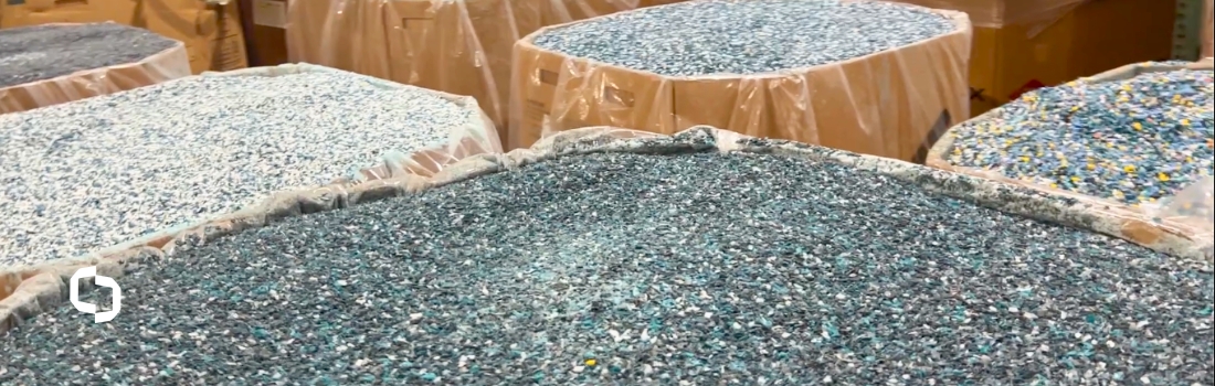 Various types of recycled plastic materials sorted in bulk containers at Extera, showcasing sustainable plastics used in plastic manufacturing.