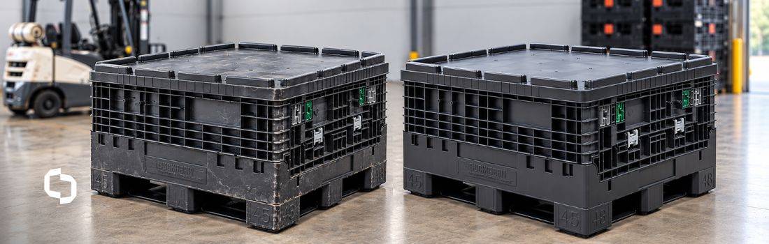 Two black reusable bulk containers, one visibly worn and one newer, sit side by side in a warehouse near a forklift and pallet stacks.