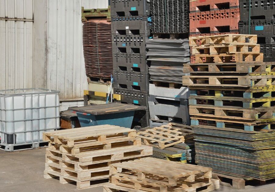 Huge piles of different types of pallets at a warehouse.